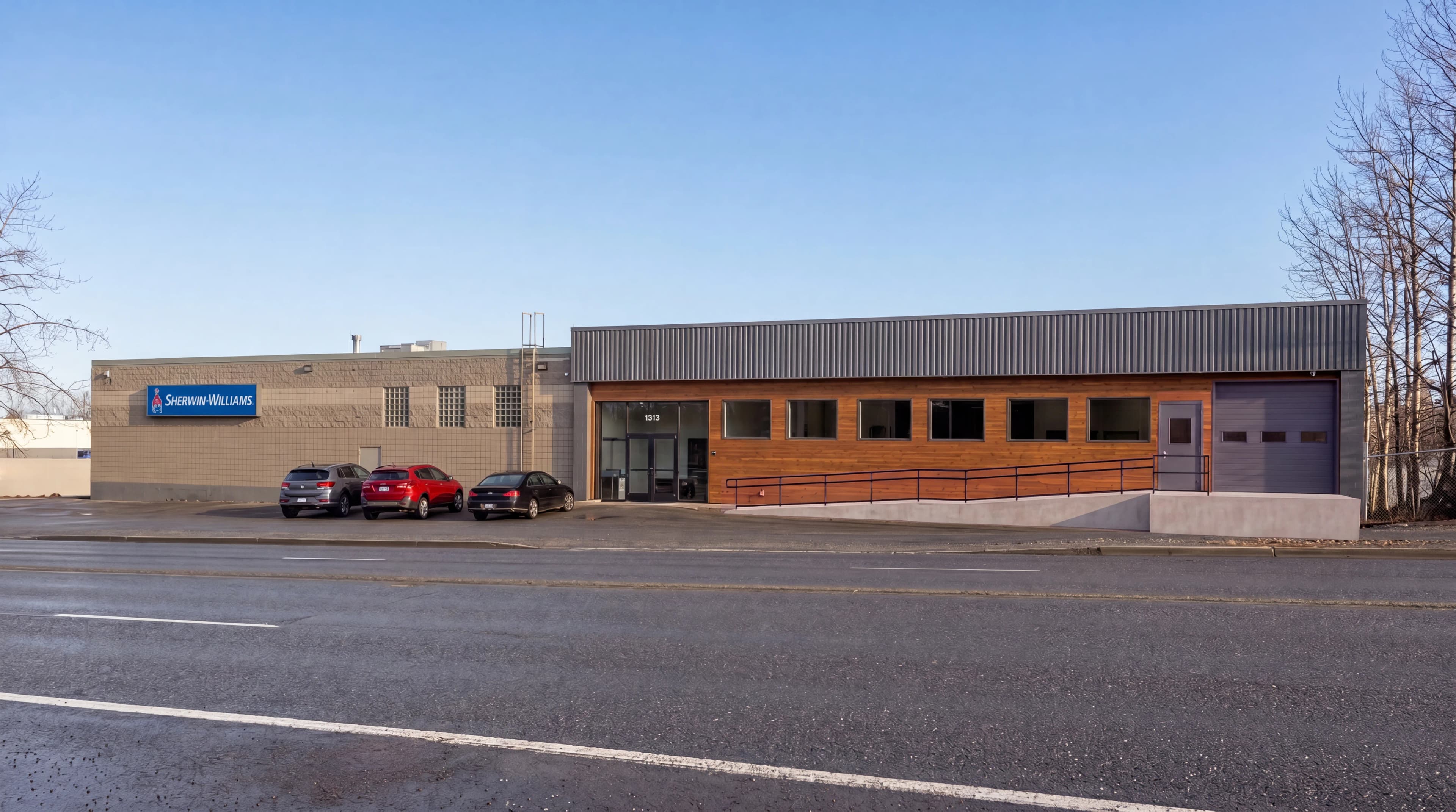 Architectural rendering of the renovated 1313 E 3rd Ave exterior with new ADA ramp and loading dock